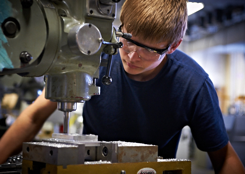 action photo of student with milling machine